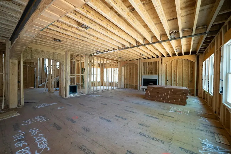 Room mid-build with new timber floor and stud walls