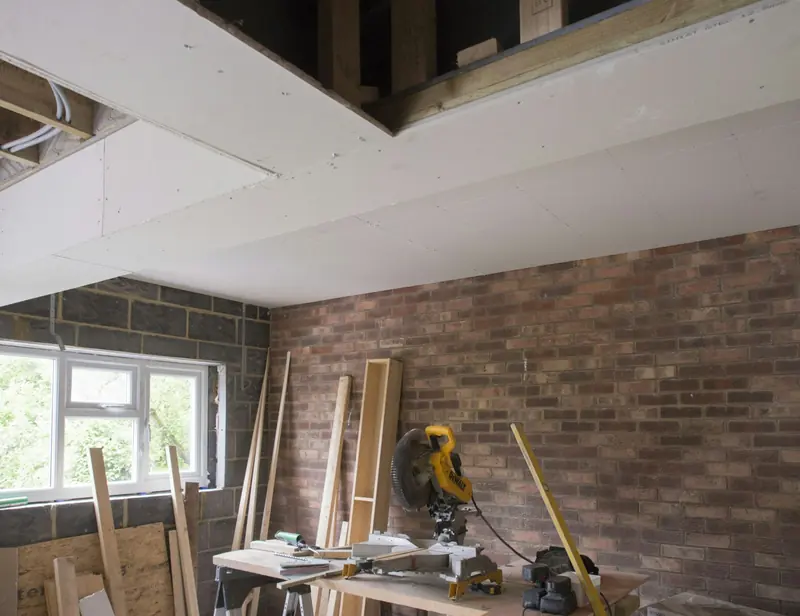 Room under renovation with exposed brick