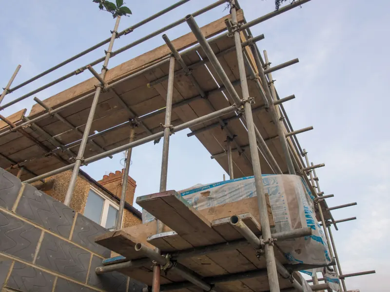 Scaffold and ladder at roof level on a house