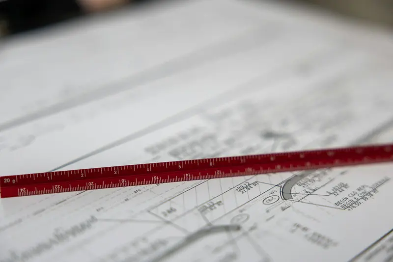 Scale ruler laid across construction drawings