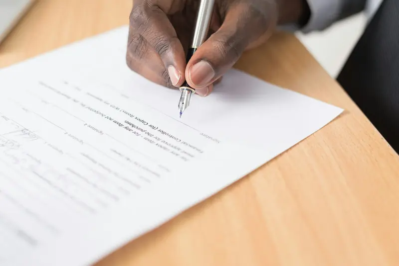 Signing paperwork at a desk