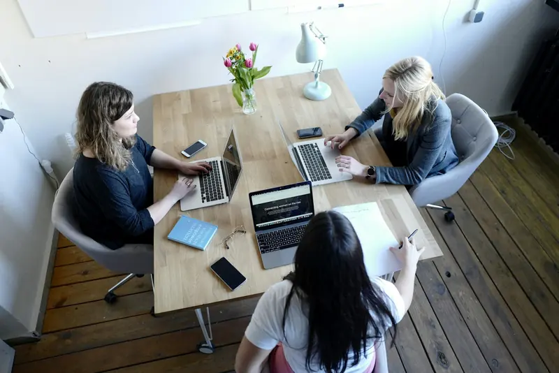 Small team working at a table from above