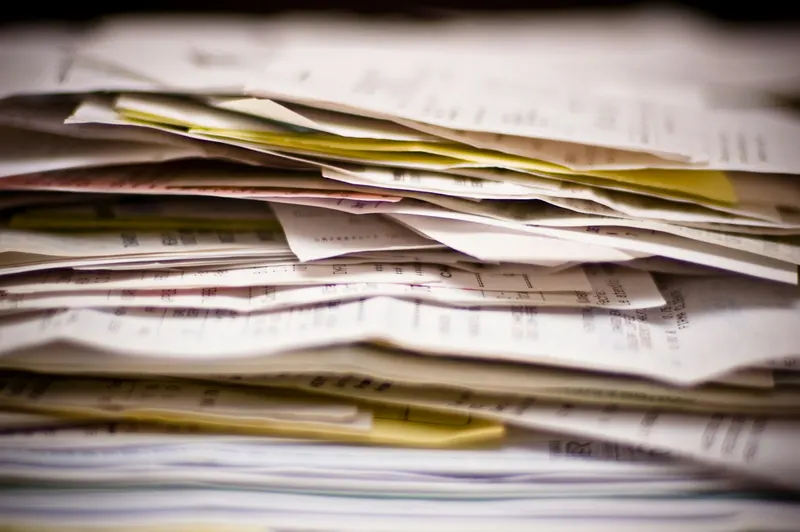 Thick stack of invoices and paperwork