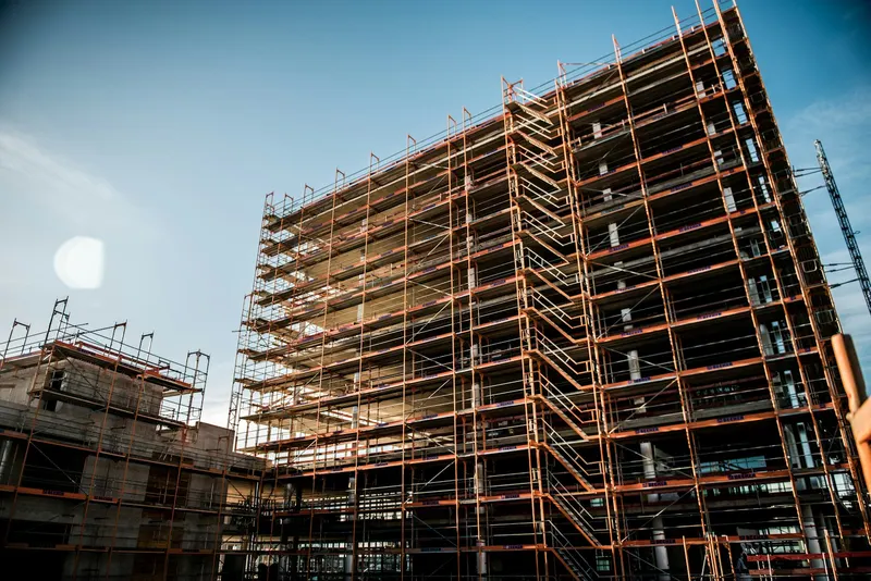 Tall building wrapped in scaffolding during construction
