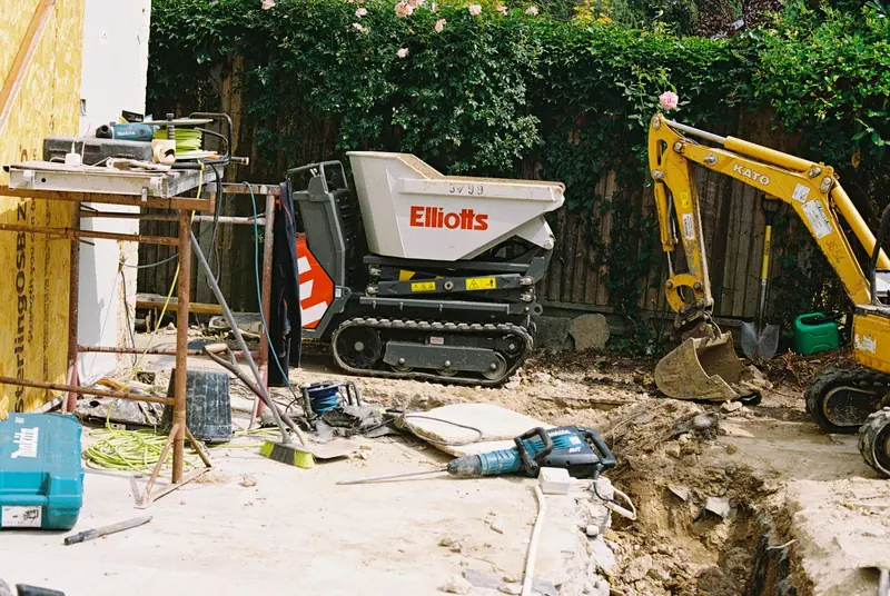 Tracked dumper and excavator on a residential construction site