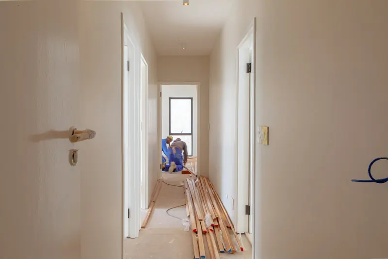Two builders working on a house