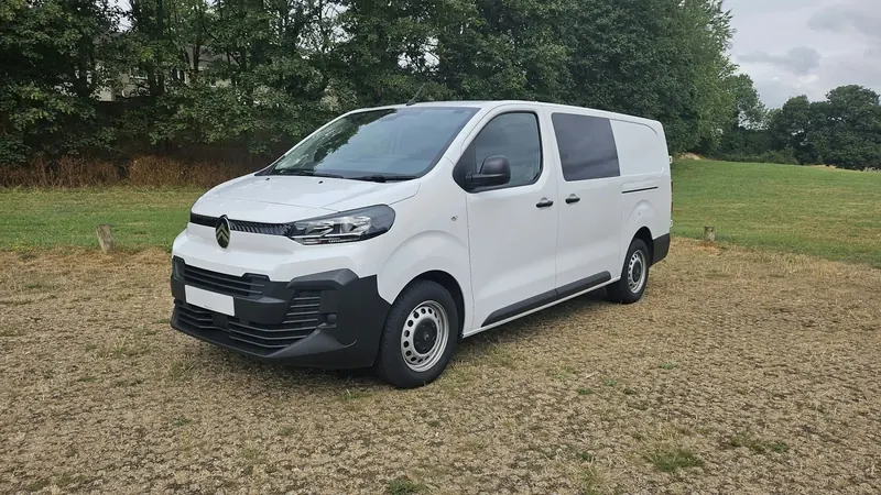 White panel van parked on gravel