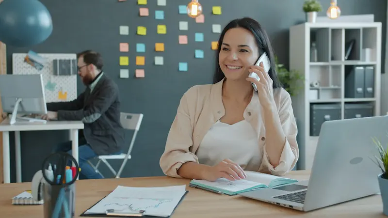 Woman on a phone call at her desk