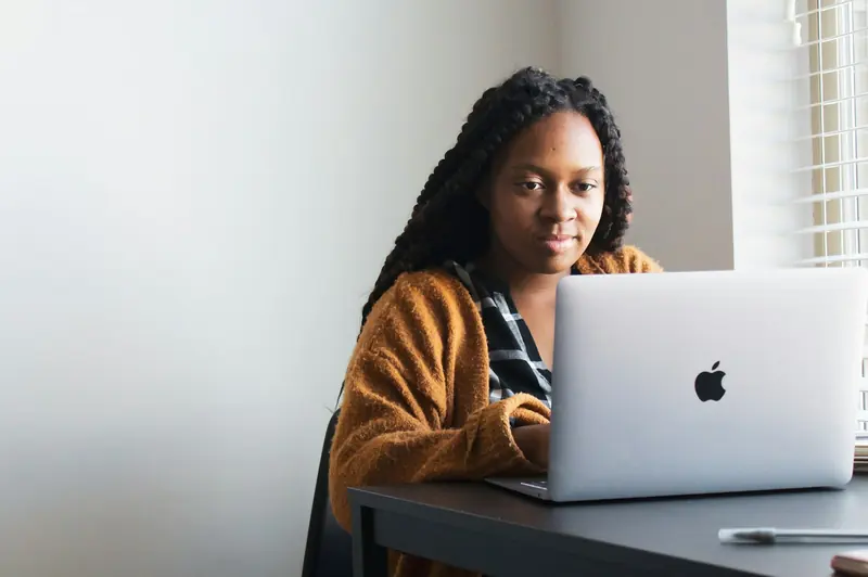 Woman working on a laptop at her desk