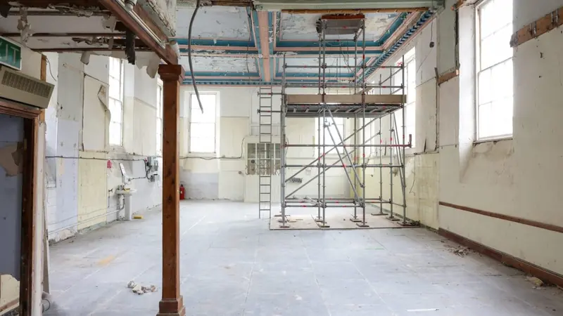 Strip-out works with scaffold towers inside an old building