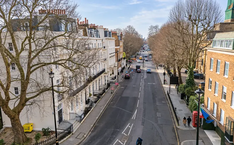 Tree-lined London street in SW1 with white stucco terraces